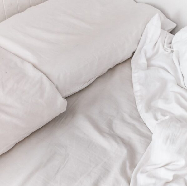white textile on white bed