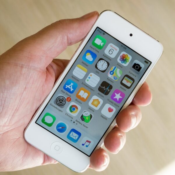 person holding white iPod touch