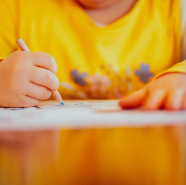 person sitting and writing don