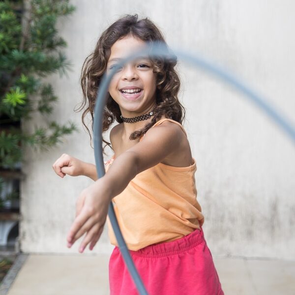 girl playing hula hoop on his arm