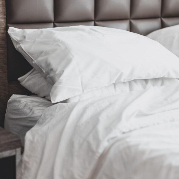 white bed pillow on bed
