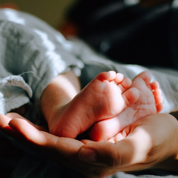 person holding baby feet