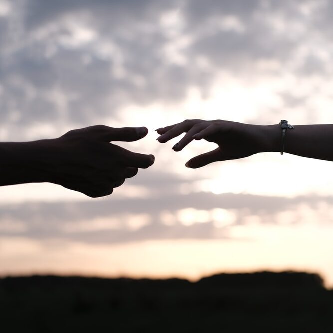 persons hand with heart shaped sign