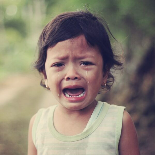 selective focus photography of girl crying