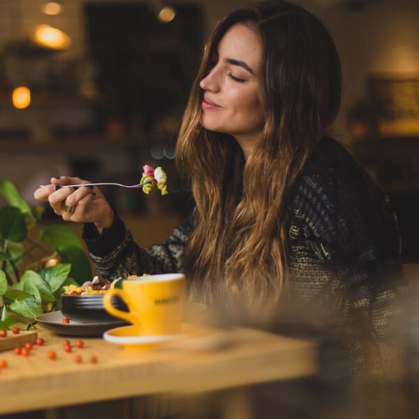woman holding fork in front table