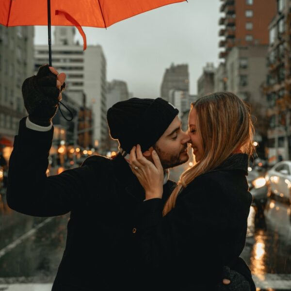 woman in black jacket holding red umbrella during daytime