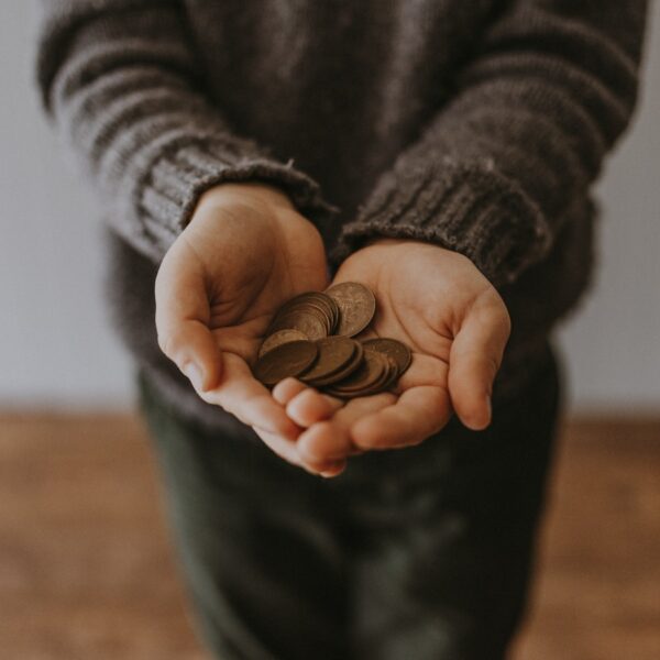 copper-colored coins on in person's hands