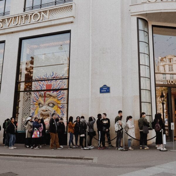 people queuing beside Louis Vuitton store