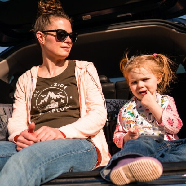 woman in black crew neck t-shirt and blue denim jeans sitting on car seat