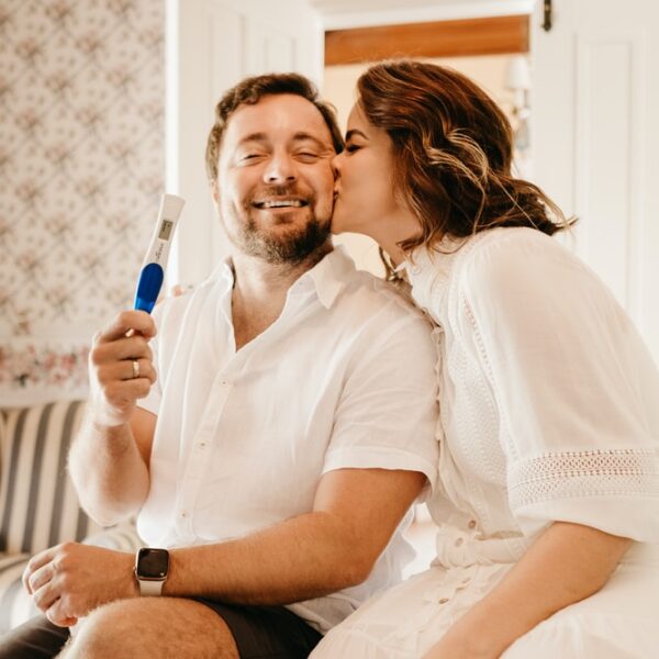 man in white button up shirt sitting beside woman in white shirt